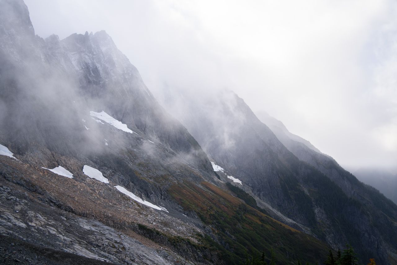 Foggy view of rugged mountains in North Cascades National Park in fall.