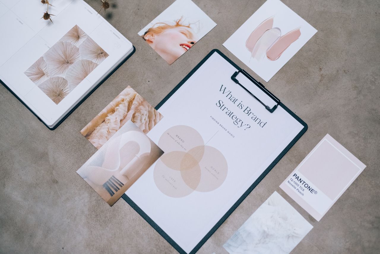 about-bg Flat lay showing branding materials and design concepts for creative strategy discussions.